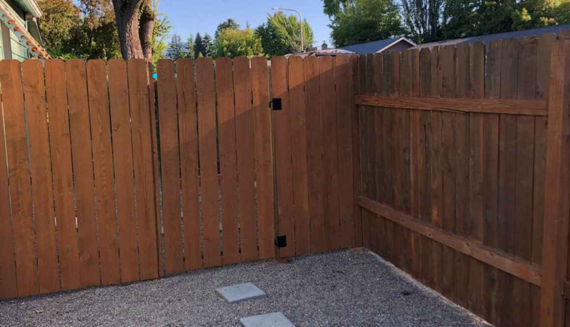 A maintained wood fence that was recently stained