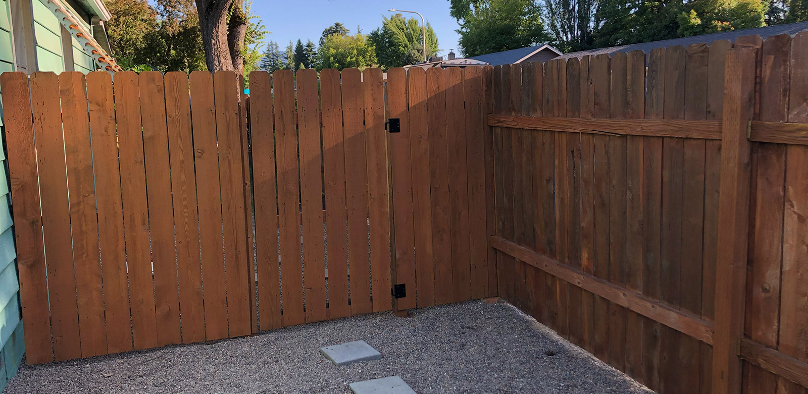 A maintained wood fence that was recently stained