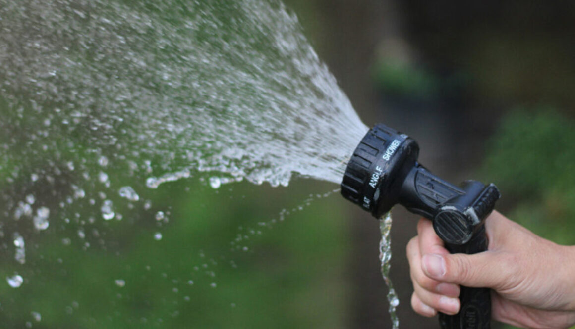 Soft wash hose being sprayed into the air