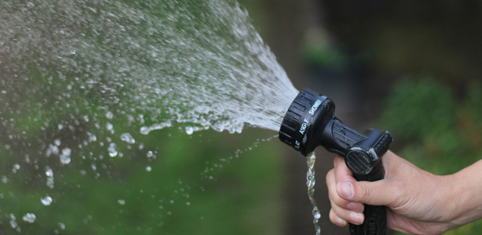 Soft wash hose being sprayed into the air